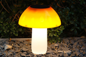 Naturnahe Solar Pilze als Gartendeko mit warmem LED-Schein zwischen Pflanzen und Stauden