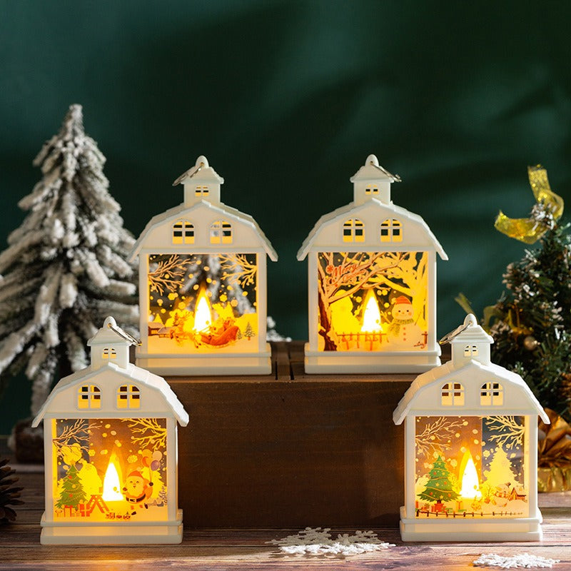 Weisse Weihnachtslaternen mit verschiedenen Motiven auf Holzpodesten