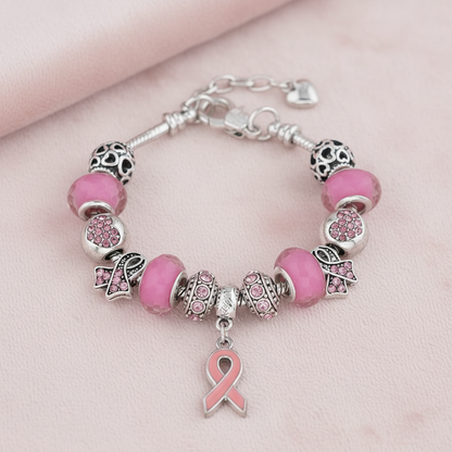 Detailansicht des Pink Ribbon Charm Armbands mit rosa Schleife und Kristall-Charms. Zeige Solidarität mit dem Pink Ribbon Armband Brustkrebs.